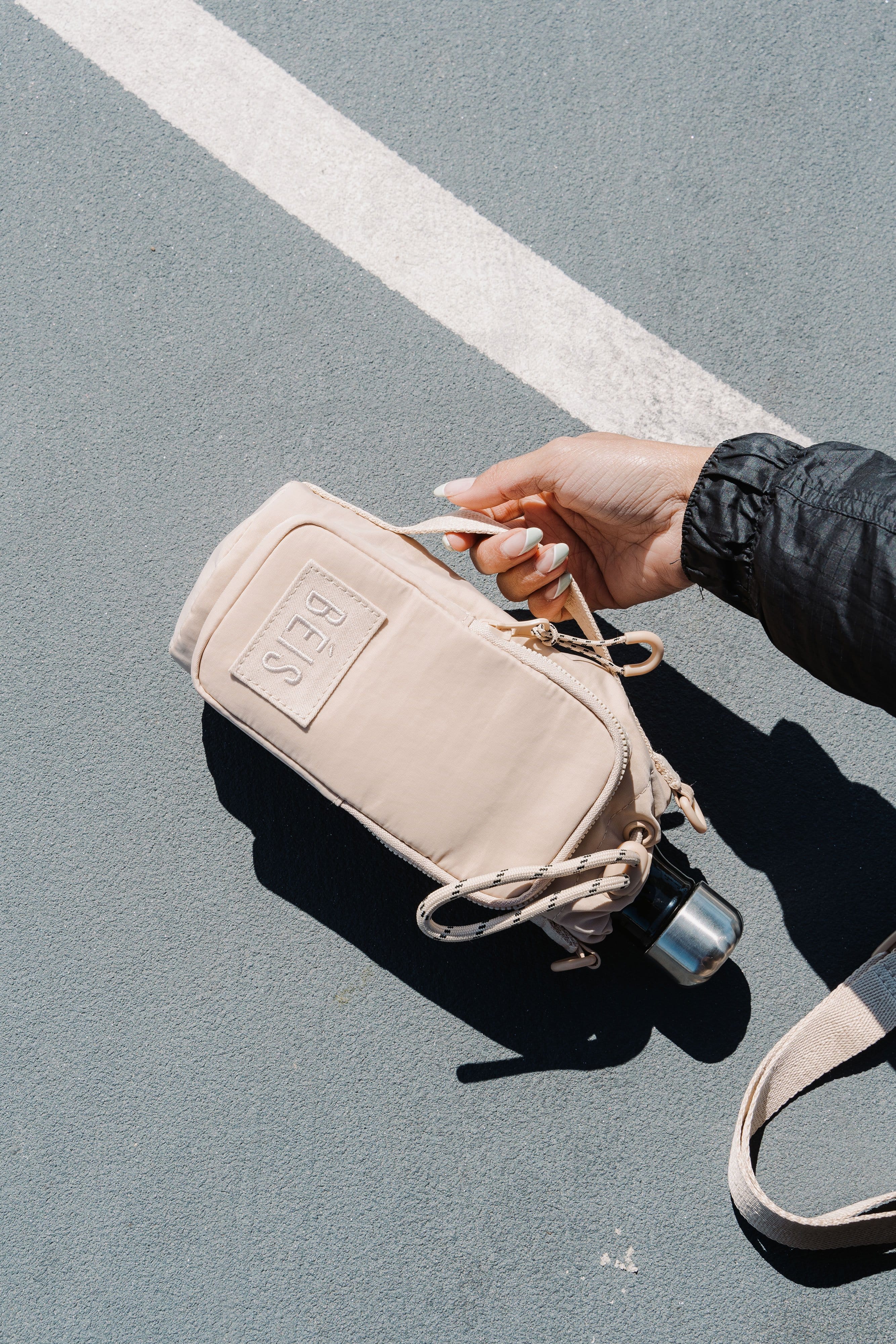 Water Bottle Sling Beige Side Handle on Court